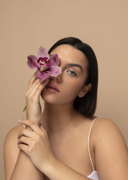vista-frontal-mujer-joven-posando-con-flor